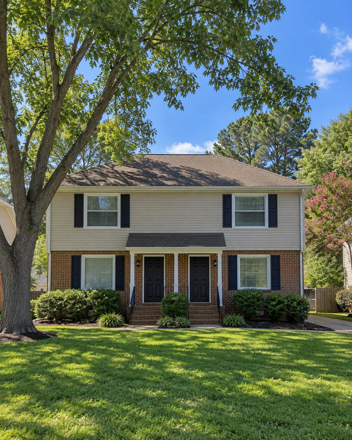 Norfolk duplex with lawn and shade trees